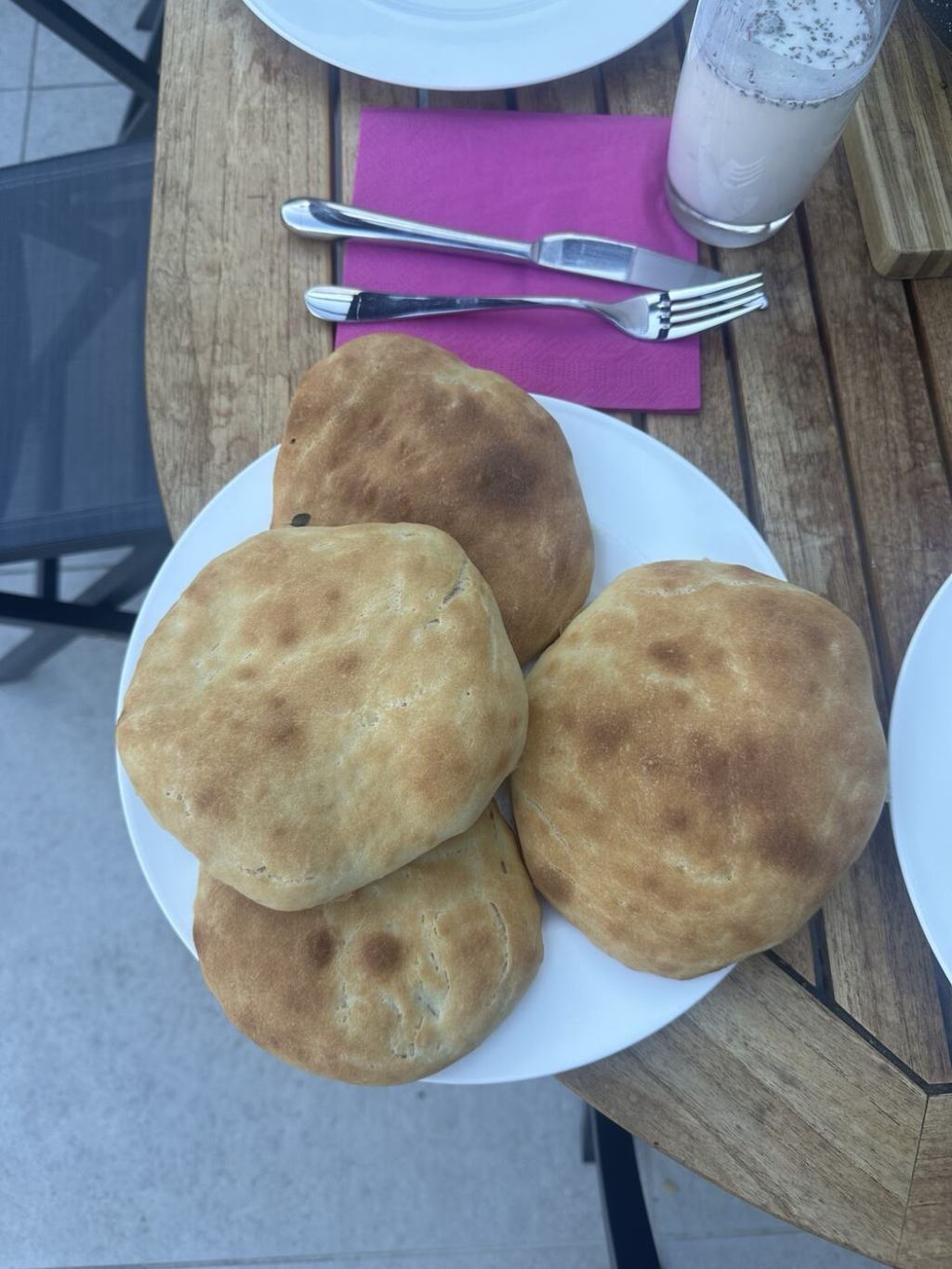 Freshly baked soft Afghan-style naan on a plate.
