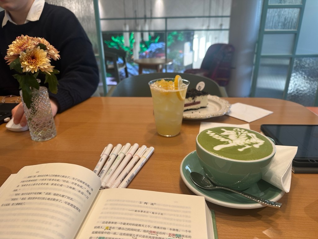 Chinese study book, pens and matcha during a café study session in Beijing